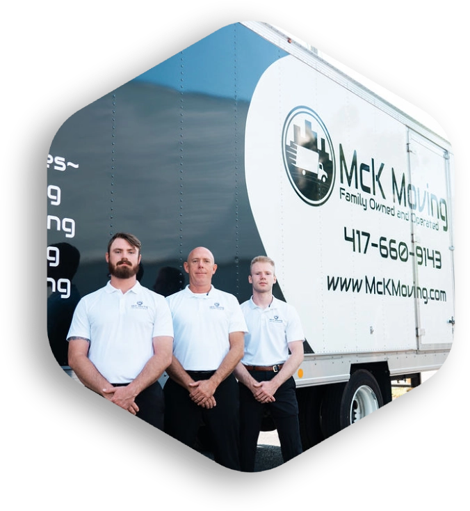 Three men standing in front of a moving truck.