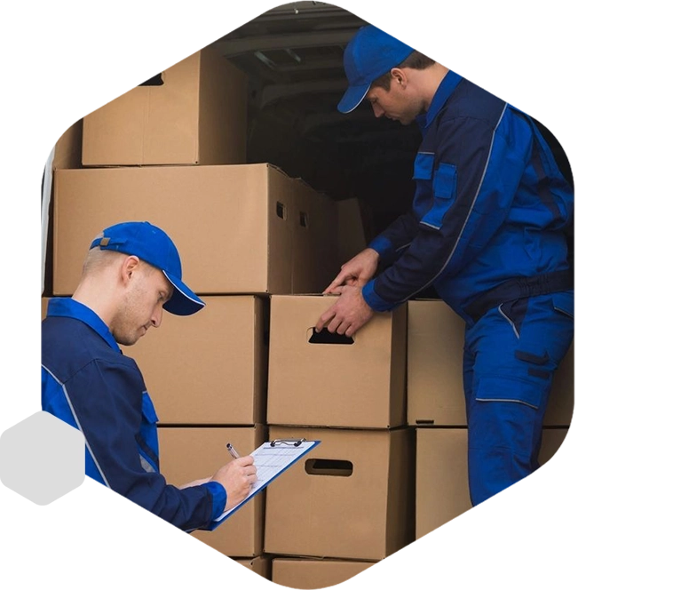 Two men in blue jackets and hats standing next to boxes.