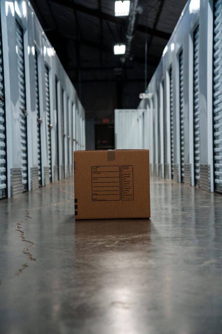 A cardboard box in an empty storage unit.