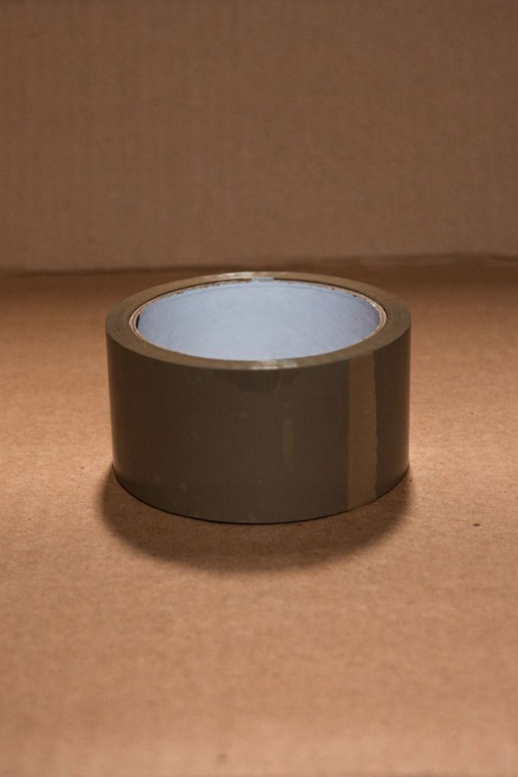 A roll of brown tape on top of a table.