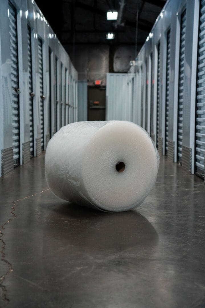 A roll of plastic wrap in an empty storage unit.